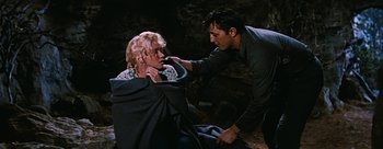 Movie still from “River of No Return” (1954), directed by Otto Preminger – A man and a woman in the dark; Medium shot, High angle