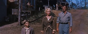 Movie still from “River of No Return” (1954), directed by Otto Preminger – A woman and two children in a dirt field; Medium shot, Low angle