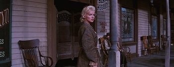 Movie still from “River of No Return” (1954), directed by Otto Preminger – A woman standing on the side of a building; Medium shot, Low angle