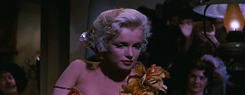 Movie still from “River of No Return” (1954), directed by Otto Preminger – A woman with a flower in her hair; Close Up shot, Over the shoulder angle