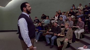 Movie still from “Road Trip” (2000), directed by Todd Phillips – A group of people sitting in front of a man in a classroom; Medium shot, High angle