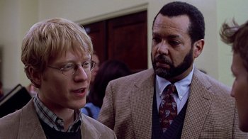 Movie still from “Road Trip” (2000), directed by Todd Phillips – A man and a woman standing next to each other in a room; Close Up shot, Over the shoulder angle