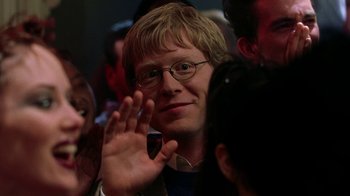 Movie still from “Road Trip” (2000), directed by Todd Phillips – A man with glasses is waving at a crowd; Close Up shot, Over the shoulder angle