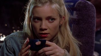 Movie still from “Road Trip” (2000), directed by Todd Phillips – A woman holding a coffee cup in her hands; Close Up shot, Over the shoulder angle