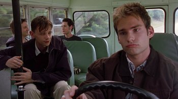Movie still from “Road Trip” (2000), directed by Todd Phillips – Three young men sitting on a bus together; Close Up shot, Low angle