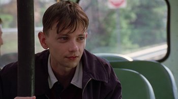 Movie still from “Road Trip” (2000), directed by Todd Phillips – A man sitting on a bus looking at the camera; Close Up shot, Low angle