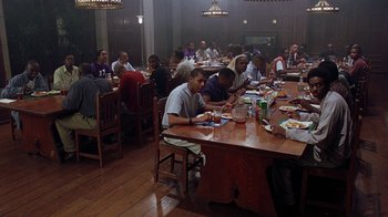Movie still from “Road Trip” (2000), directed by Todd Phillips – A group of people sitting at a table eating food; Wide shot, High angle
