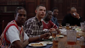Movie still from “Road Trip” (2000), directed by Todd Phillips – A group of people sitting at a table eating; Medium shot, Low angle
