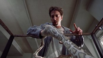 Movie still from “Road Trip” (2000), directed by Todd Phillips – A man holding a snake in his hands; Close Up shot, Low angle