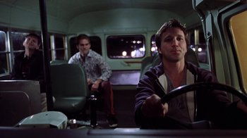 Movie still from “Road Trip” (2000), directed by Todd Phillips – Two men sitting in a bus at night; Medium shot, Low angle