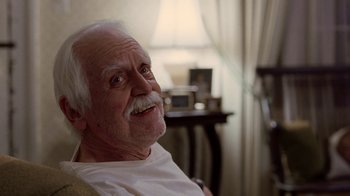 Movie still from “Road Trip” (2000), directed by Todd Phillips – An older man sitting in front of a window; Close Up shot, Low angle