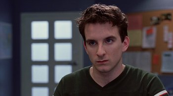 Movie still from “Road Trip” (2000), directed by Todd Phillips – A person wearing a green shirt; Close Up shot, Over the shoulder angle
