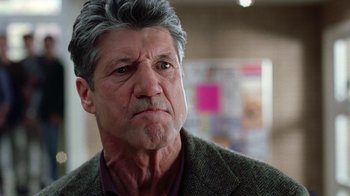 Movie still from “Road Trip” (2000), directed by Todd Phillips – An older man in a green jacket looks at the camera; Close Up shot, Low angle