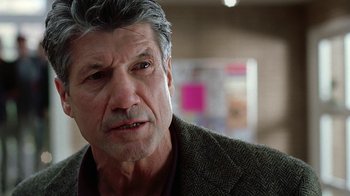 Movie still from “Road Trip” (2000), directed by Todd Phillips – An older man wearing a brown jacket looking at the camera; Close Up shot, Over the shoulder angle