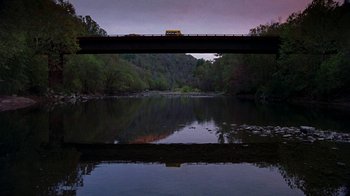 Movie still from “Road Trip” (2000), directed by Todd Phillips – A bridge over a body of water at night; Extreme Wide shot, Low angle