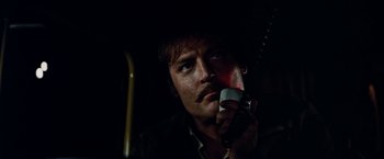 Movie still from “Road Games” (1981), directed by Richard Franklin – A man holding a cell phone up to his mouth; Close Up shot, Low angle