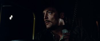 Movie still from “Road Games” (1981), directed by Richard Franklin – A person holding a cell phone; Close Up shot, Low angle