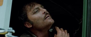 Movie still from “Road Games” (1981), directed by Richard Franklin – A person holding a cell phone; Close Up shot, Low angle