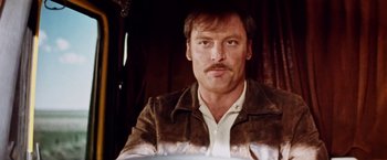 Movie still from “Road Games” (1981), directed by Richard Franklin – A person wearing a jacket; Close Up shot, Low angle