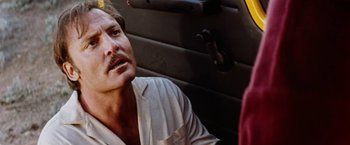 Movie still from “Road Games” (1981), directed by Richard Franklin – A person sitting in a car; Close Up shot, Low angle