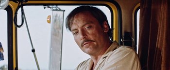 Movie still from “Road Games” (1981), directed by Richard Franklin – A person on a train; Close Up shot, Low angle