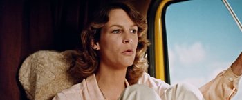 Movie still from “Road Games” (1981), directed by Richard Franklin – A person sitting in a car; Close Up shot, Low angle