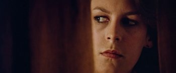 Movie still from “Road Games” (1981), directed by Richard Franklin – A woman's face looking at the camera; Close Up shot, Low angle