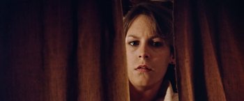 Movie still from “Road Games” (1981), directed by Richard Franklin – A person looking at the camera; Close Up shot, Low angle