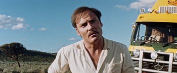 Movie still from “Road Games” (1981), directed by Richard Franklin – A person wearing a white shirt; Close Up shot, Low angle