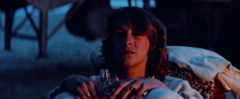 Movie still from “Road Games” (1981), directed by Richard Franklin – A person holding a wine glass in their hands; Close Up shot, Low angle