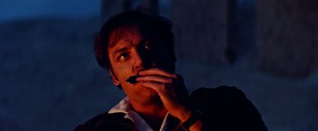 Movie still from “Road Games” (1981), directed by Richard Franklin – A man with a cigarette in his mouth at night; Close Up shot, Low angle