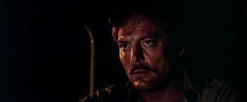 Movie still from “Road Games” (1981), directed by Richard Franklin – A person with a beard and mustache; Close Up shot, Low angle