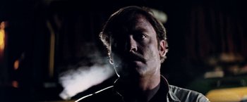 Movie still from “Road Games” (1981), directed by Richard Franklin – A person smoking a cigarette in the dark; Close Up shot, Low angle