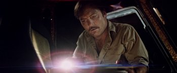 Movie still from “Road Games” (1981), directed by Richard Franklin – A person with a flashlight; Close Up shot, Low angle