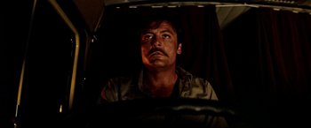 Movie still from “Road Games” (1981), directed by Richard Franklin – A person with a umbrella; Close Up shot, Low angle