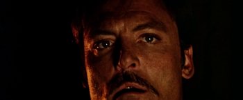 Movie still from “Road Games” (1981), directed by Richard Franklin – A man's face with a mustache; Extreme Close Up shot, Low angle