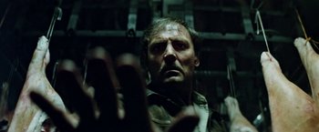 Movie still from “Road Games” (1981), directed by Richard Franklin – A person holding something in his hand; Close Up shot, Low angle