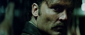 Movie still from “Road Games” (1981), directed by Richard Franklin – A man's face with a mustache; Close Up shot, Low angle