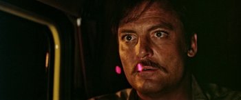 Movie still from “Road Games” (1981), directed by Richard Franklin – A person with a beard and mustache; Close Up shot, Low angle