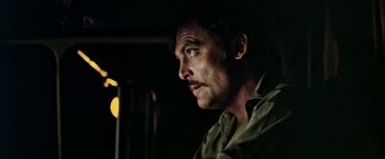 Movie still from “Road Games” (1981), directed by Richard Franklin – A person wearing a shirt; Close Up shot, Low angle