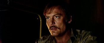 Movie still from “Road Games” (1981), directed by Richard Franklin – A person with a mustache; Close Up shot, Low angle