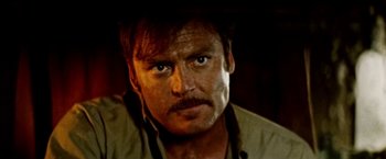 Movie still from “Road Games” (1981), directed by Richard Franklin – A person with a mustache; Close Up shot, Over the shoulder angle