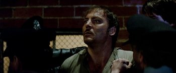 Movie still from “Road Games” (1981), directed by Richard Franklin – A person wearing a shirt; Close Up shot, Low angle