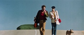 Movie still from “Road Games” (1981), directed by Richard Franklin – A man and a woman walking down a street; Wide shot, Low angle
