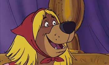 Movie still from “Robin Hood” (1973), directed by David Hand – A cartoon dog's face with long blond hair; Close Up shot, Low angle