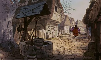 Movie still from “Robin Hood” (1973), directed by David Hand – An animated picture of a street with a person walking by a water well; Wide shot, Low angle