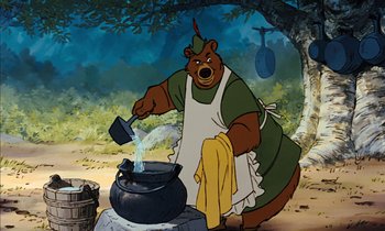 Movie still from “Robin Hood” (1973), directed by David Hand – A cartoon bear is cooking something in a cauldron; Medium shot, Low angle