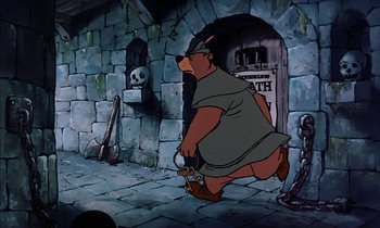 Movie still from “Robin Hood” (1973), directed by David Hand – A painting of a bear in a dungeon with a skull and crossbones on the wall behind him; Wide shot, High angle