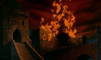 Movie still from “Robin Hood” (1973), directed by David Hand – A castle with a tower on fire in the middle of the night; Extreme Wide shot, Low angle