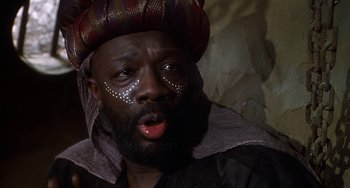 Movie still from “Robin Hood: Men in Tights” (1993), directed by Mel Brooks – A man with a beard and a hat on his head; Close Up shot, Low angle